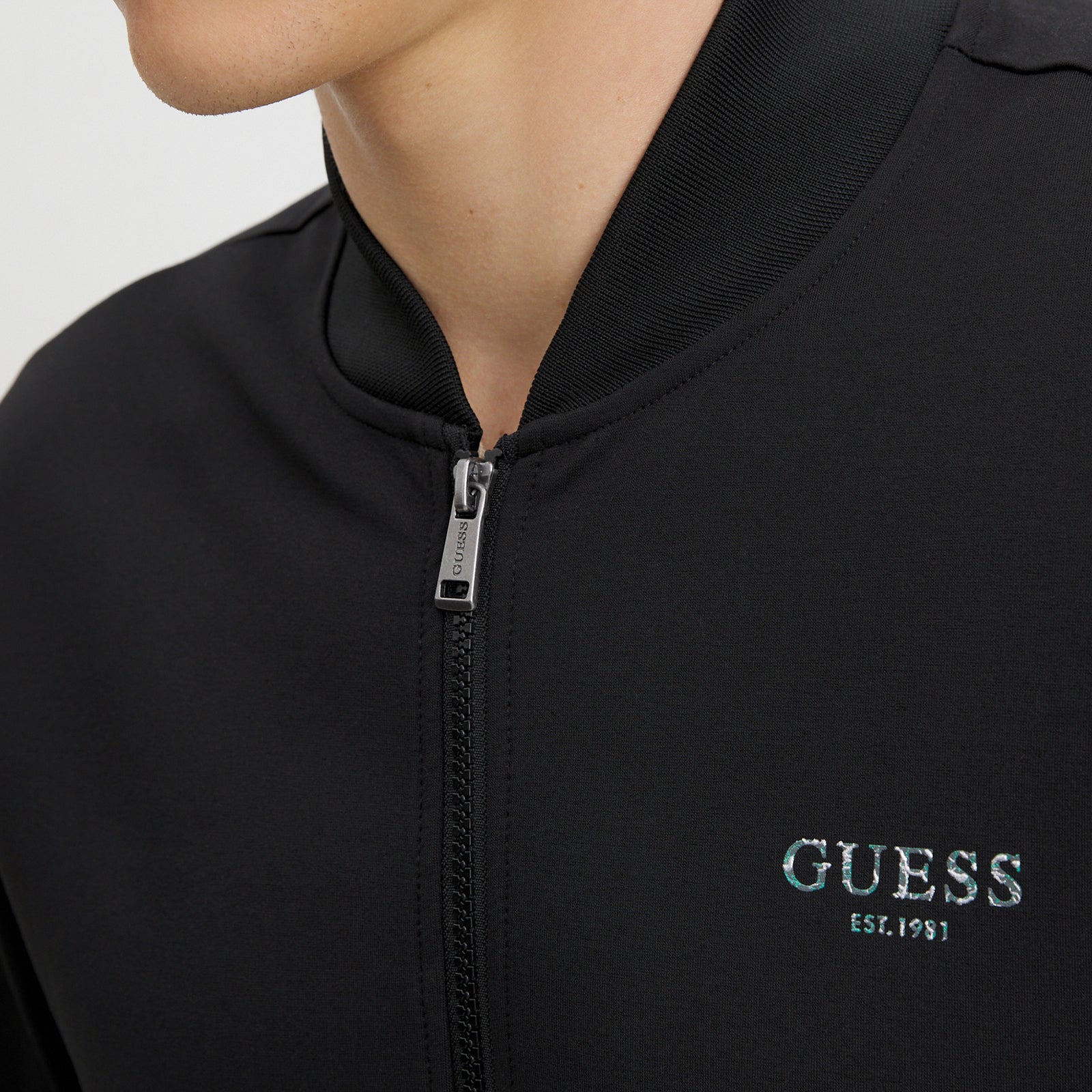 FELPA GUESS BOMBER IRIDESCENT TRUCK